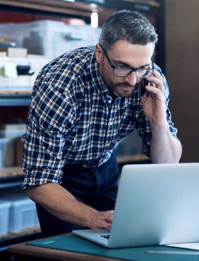 man reviewing his business account with free online banking